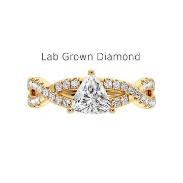 Close-up of trillion cut lab diamond ring with halo and studded shank in recycled gold, Elegant side view of handmade lab-grown diamond ring in yellow gold with detailed shank,
