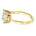 Gold ring with a princess -shaped diamond on a white background