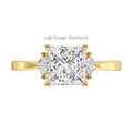Gold ring with a lab-grown princess diamond marquise side assents on a white background