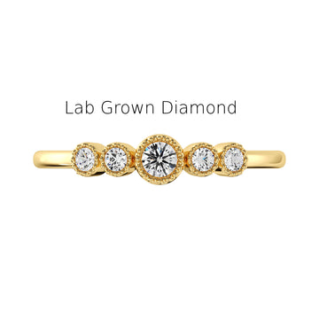 Gold ring with lab-grown diamonds on a white background